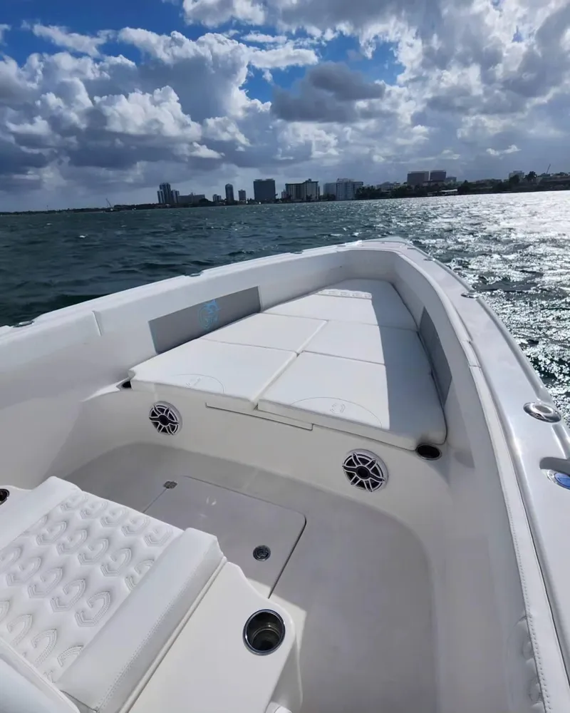 Slide: The Image of 2023 CG Boat Works 35 M-Series on water with city skyline in background. - 20