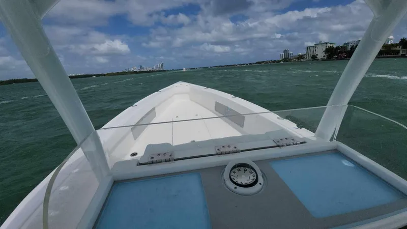 Slide: The Image of 2023 CG Boat Works 35 M-Series on open water with city skyline in background. - 21