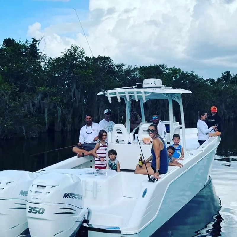 Slide: The Image of Family enjoying a day on a 2023 CG Boat Works 35 M-Series boat. - 22