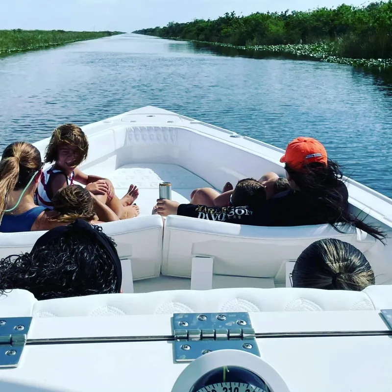Slide: The Image of Group enjoying a ride on a 2023 CG Boat Works 35 M-Series in a scenic waterway. - 25