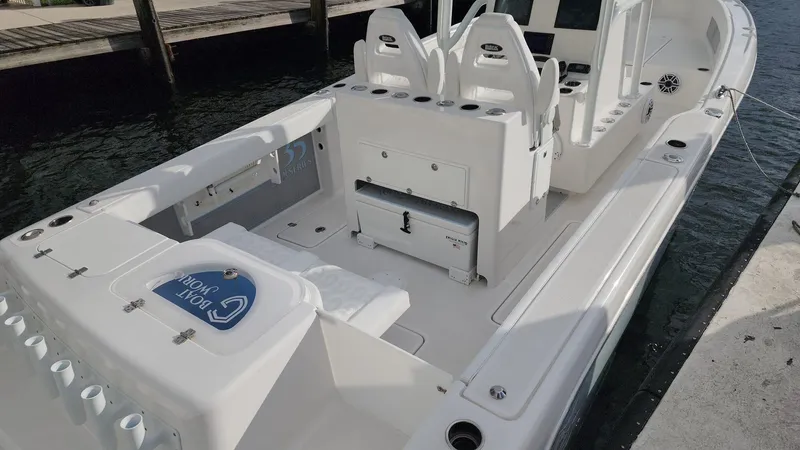 Slide: The Image of 2023 CG Boat Works 35 M-Series, docked, showcasing spacious deck and seating. - 26