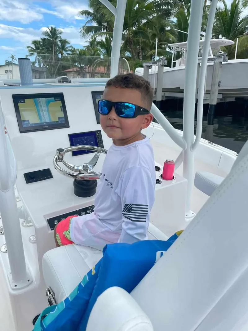 Slide: The Image of Young boy on a 2023 CG Boat Works 35 M-Series, wearing sunglasses and a white shirt. - 32