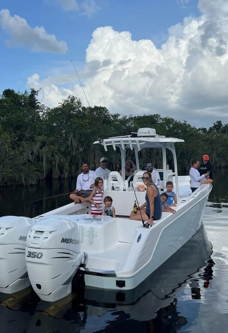 Slide: The Image of 2023 CG Boat Works 35 M-Series with family fishing on a lake. - 36