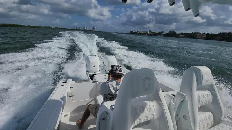 Slide: The Image of 2023 CG Boat Works 35 M-Series speeding on open water. - 37