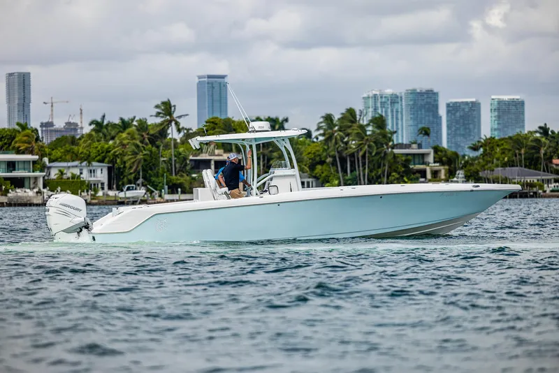 Slide: The Image of 2023 CG Boat Works 35 M-Series cruising near a city skyline. - 4