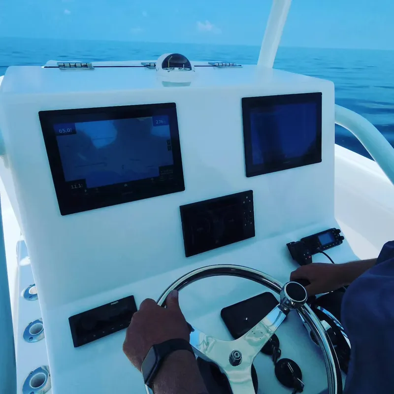 Slide: The Image of 2023 CG Boat Works 35 M-Series dashboard with navigation screens and steering wheel. - 44