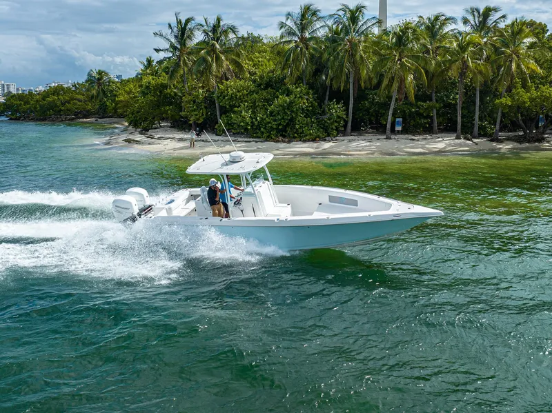 Slide: The Image of 2023 CG Boat Works 35 M-Series cruising near a tropical shoreline. - 5