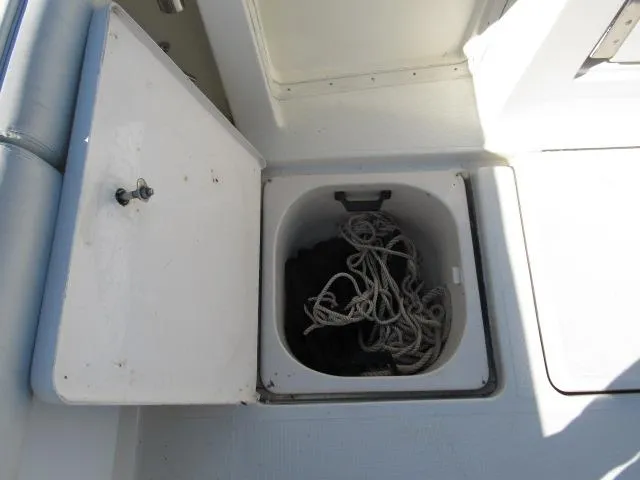 Slide: The Image of Open storage compartment on 1995 Tiara Yachts 3700 Open, containing ropes. - 13