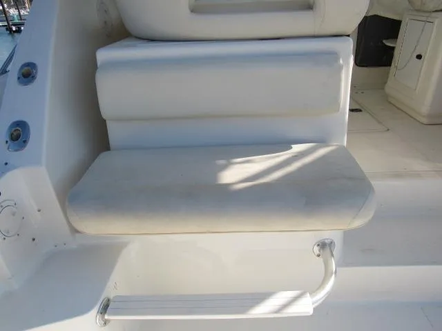 Slide: The Image of 1995 Tiara Yachts 3700 Open boat seating area with white cushions. - 16