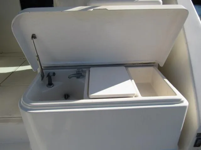Slide: The Image of 1995 Tiara Yachts 3700 Open sink and storage compartment. - 18