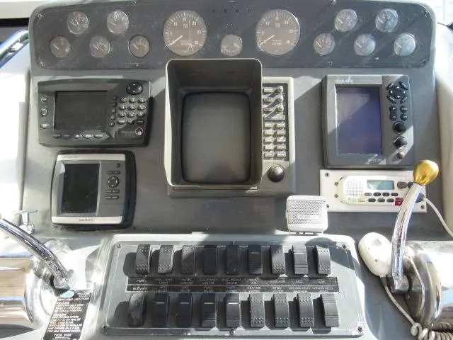 Slide: The Image of Control panel of a 1995 Tiara Yachts 3700 Open with navigation and communication equipment. - 2
