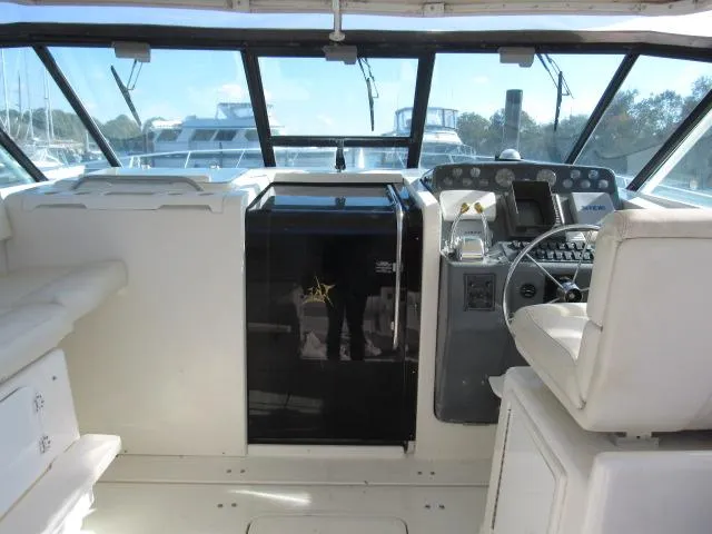 Slide: The Image of 1995 Tiara Yachts 3700 Open helm station with seating and navigation controls. - 28