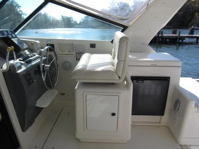 Slide: The Image of 1995 Tiara Yachts 3700 Open helm station with captain's chair and control panel. - 29