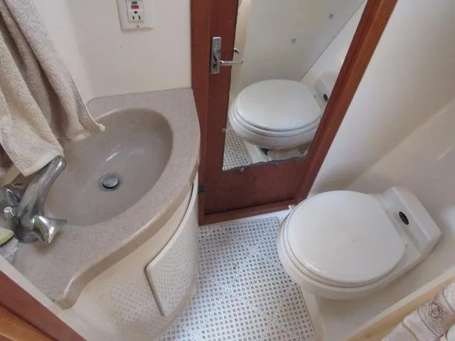 Slide: The Image of 1995 Tiara Yachts 3700 Open bathroom with sink, toilet, and mirror. - 36