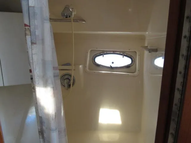 Slide: The Image of 1995 Tiara Yachts 3700 Open shower with porthole window and curtain - 37