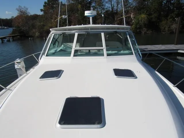 Slide: The Image of 1995 Tiara Yachts 3700 Open boat docked, front deck view. - 40