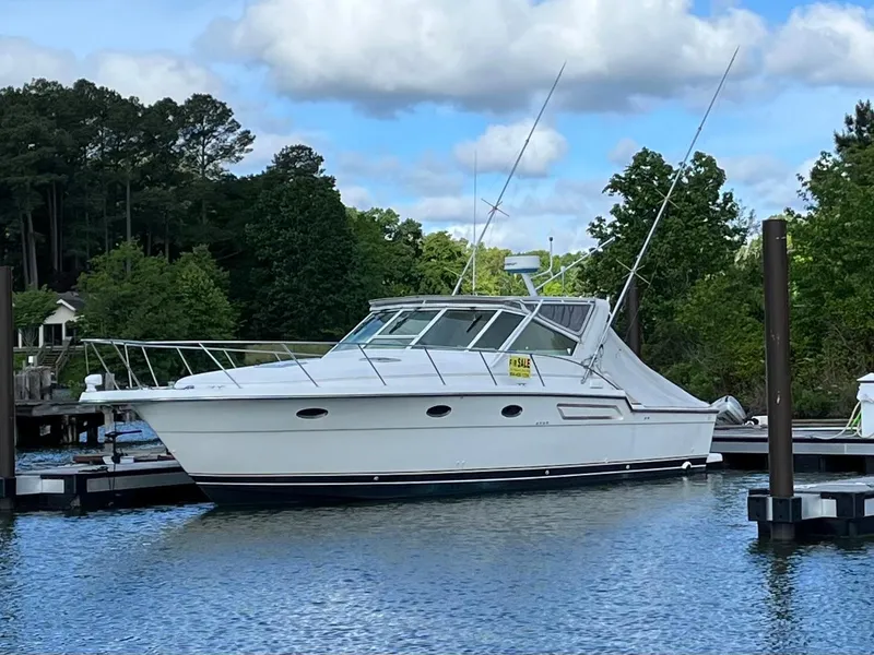 Slide: The Image of 1995 Tiara Yachts 3700 Open docked on a serene lake. - 41