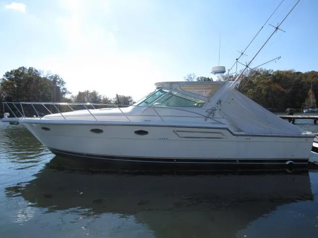 Slide: The Image of 1995 Tiara Yachts 3700 Open boat docked on calm water. - 45