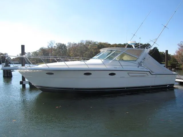 Slide: The Image of 1995 Tiara Yachts 3700 Open boat docked on calm water. - 46