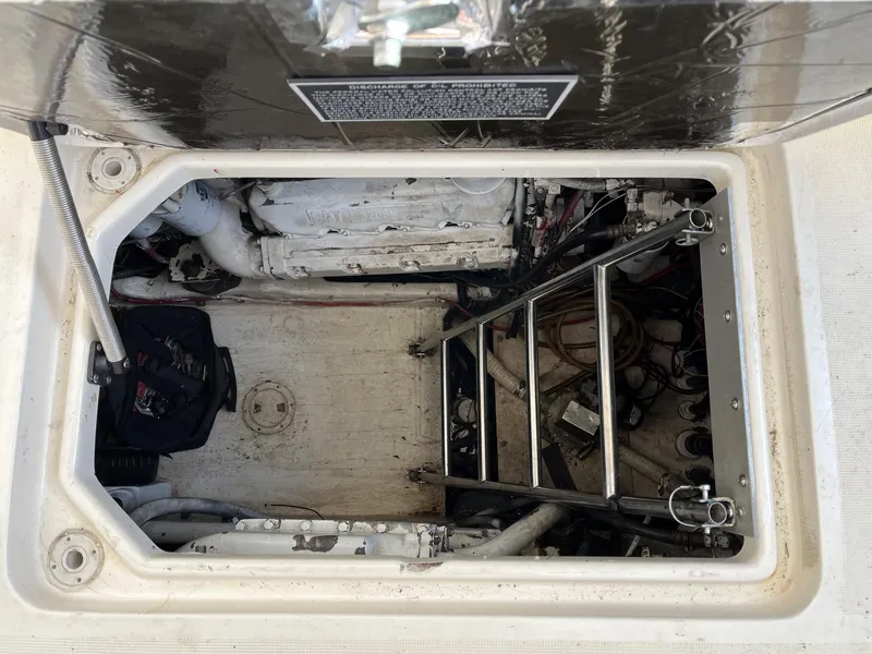 Slide: The Image of Engine compartment of a 1995 Tiara Yachts 3700 Open with ladder and equipment. - 48