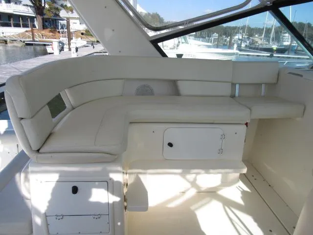 Slide: The Image of 1995 Tiara Yachts 3700 Open interior seating area with white cushions. - 6