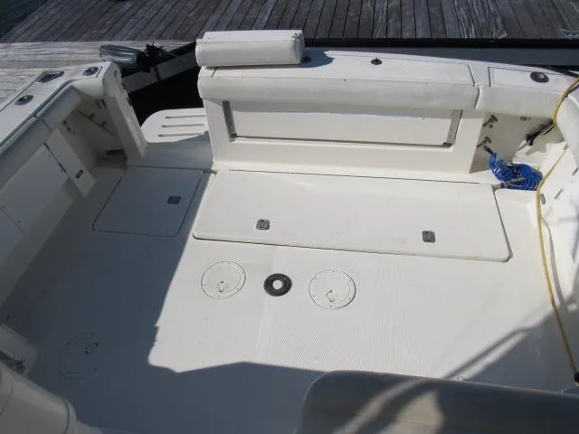 Slide: The Image of 1995 Tiara Yachts 3700 Open boat deck with white seating and storage compartments. - 9