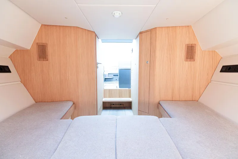Slide: The Image of 2024 Sichterman T38 yacht interior cabin with twin beds and wooden finish. - 13