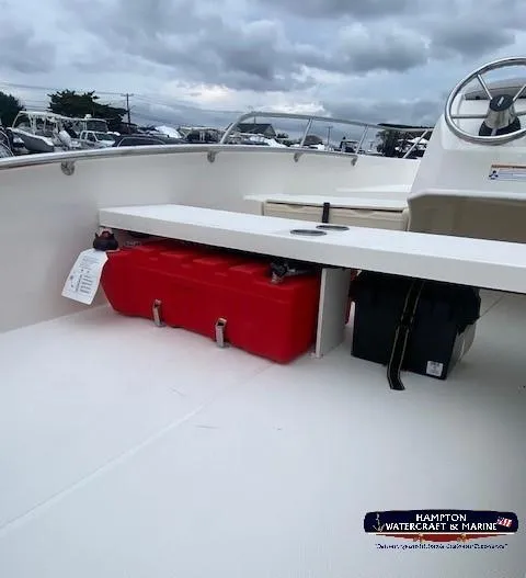 Slide: The Image of 2024 Boston Whaler 160 Super Sport boat interior with red storage box. - 14