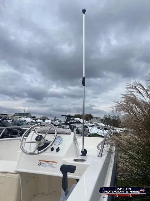 Slide: The Image of 2024 Boston Whaler 160 Super Sport boat console with steering wheel and throttle. - 15