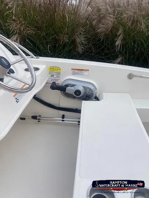 Slide: The Image of 2024 Boston Whaler 160 Super Sport interior with steering wheel and throttle controls. - 16