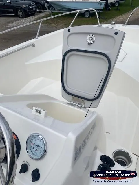 Slide: The Image of 2024 Boston Whaler 160 Super Sport boat interior with open storage compartment. - 21