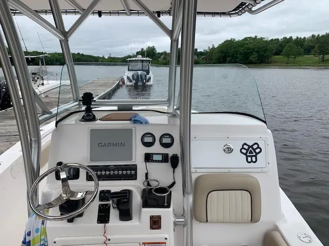 Slide: The Image of 2018 Sea Fox 249 Avenger boat dashboard with Garmin navigation system, docked by a lake. - 3