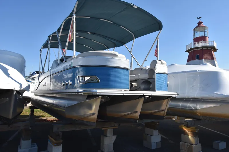 Slide: The Image of 2020 Avalon 2585 ENT SaltWater Series pontoon boat with canopy near lighthouse. - 1