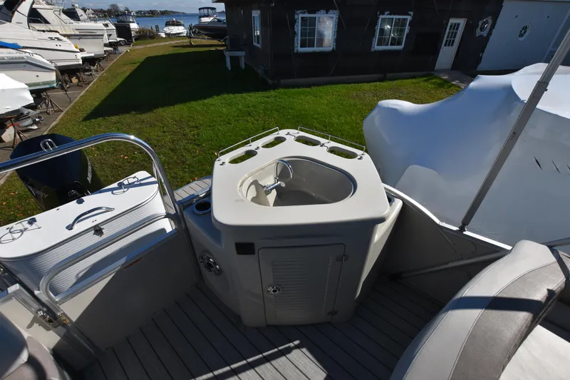 Slide: The Image of 2020 Avalon 2585 ENT SaltWater Series boat interior with sink and seating area. - 15