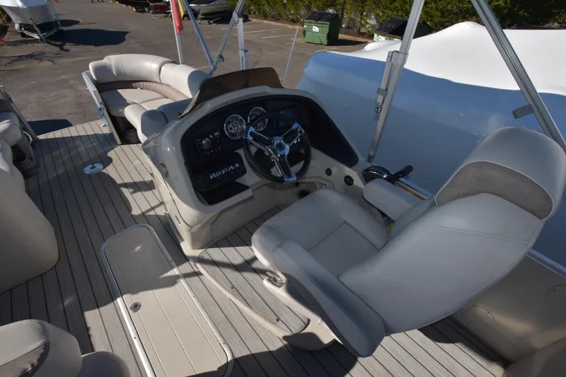 Slide: The Image of 2020 Avalon 2585 ENT SaltWater Series boat interior with captain's chair and control panel. - 17