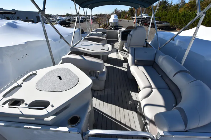 Slide: The Image of 2020 Avalon 2585 ENT SaltWater Series pontoon boat interior with seating and tables. - 6