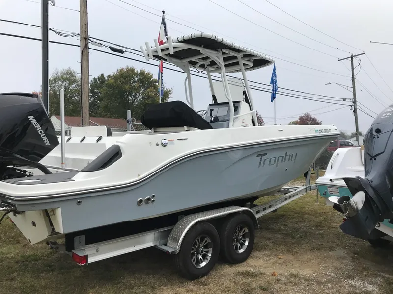 Slide: The Image of 2022 Bayliner Trophy T24CC boat on a trailer, side view. - 1