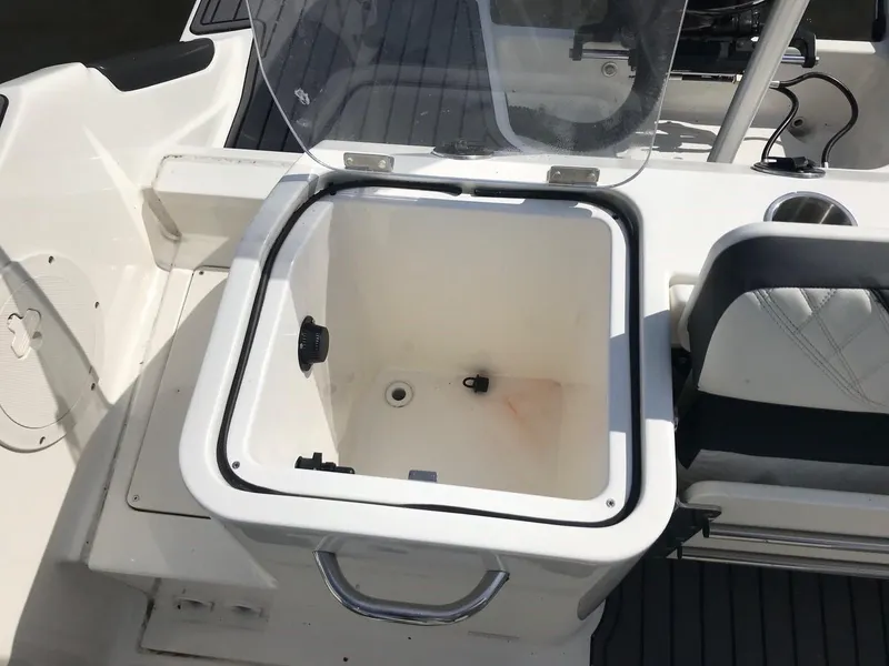 Slide: The Image of 2022 Bayliner Trophy T24CC open storage compartment on deck. - 18
