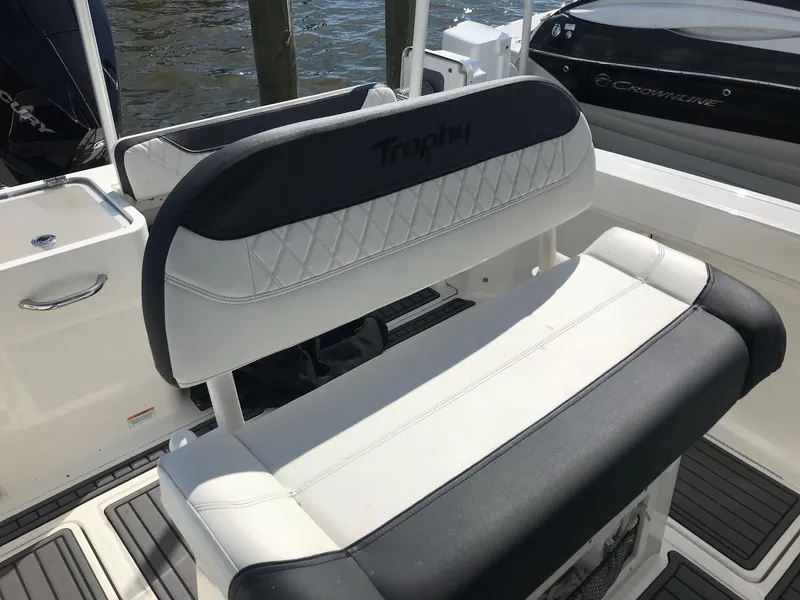 Slide: The Image of 2022 Bayliner Trophy T24CC boat seating area with white and black upholstery. - 19