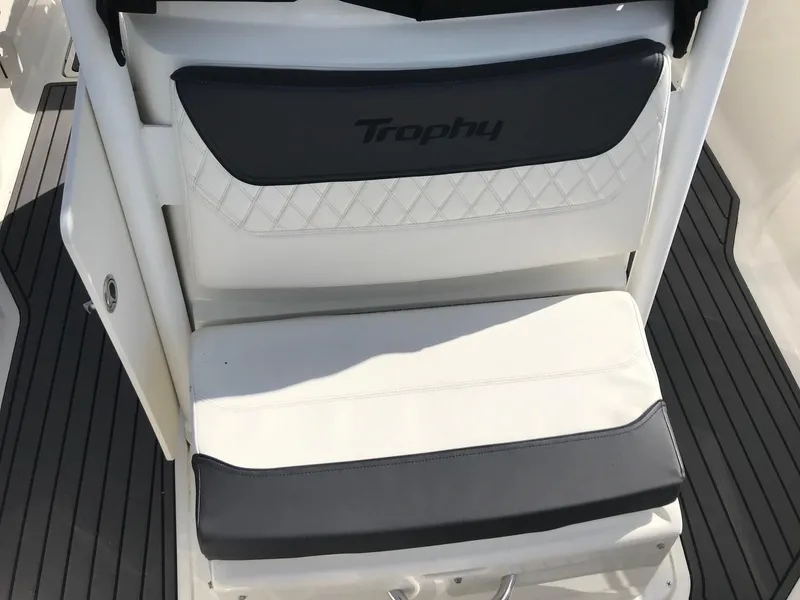 Slide: The Image of Bayliner Trophy T24CC 2022 boat seat with black and white upholstery. - 24