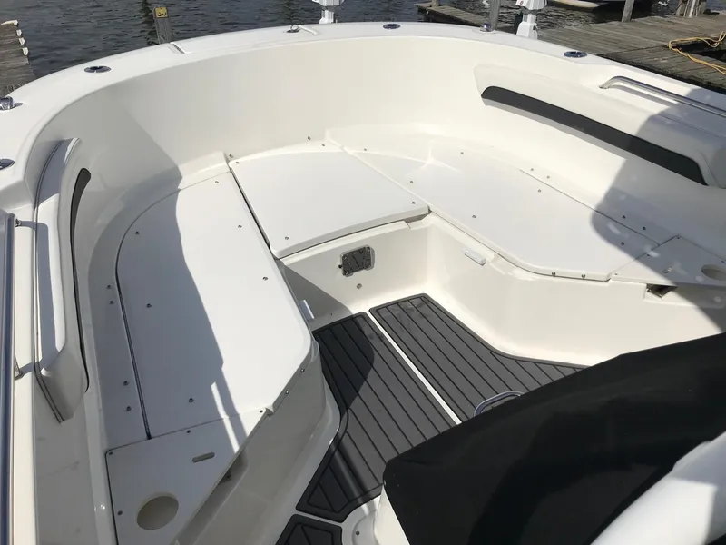 Slide: The Image of 2022 Bayliner Trophy T24CC boat interior with seating and storage compartments. - 28