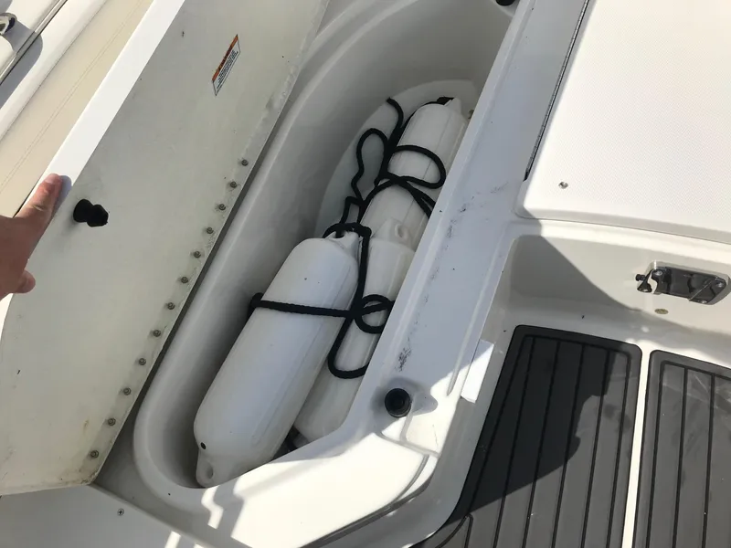 Slide: The Image of Storage compartment on a 2022 Bayliner Trophy T24CC boat with fenders. - 29
