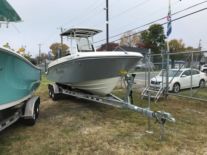 Slide: The Image of 2022 Bayliner Trophy T24CC boat on a trailer in a yard. - 3