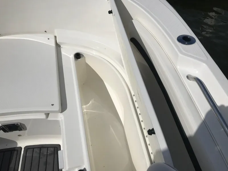 Slide: The Image of 2022 Bayliner Trophy T24CC boat interior detail showing storage compartments and deck. - 30