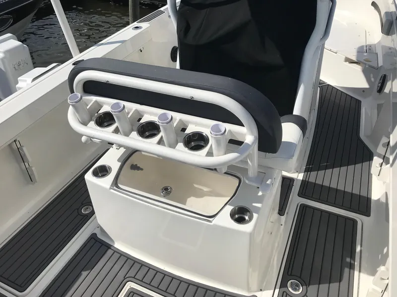 Slide: The Image of 2022 Bayliner Trophy T24CC boat interior with rod holders and seating. - 34