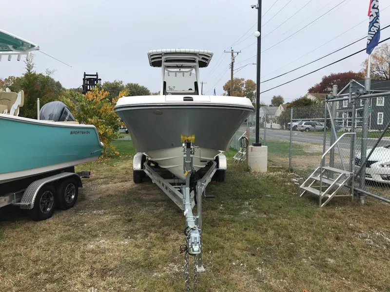 Slide: The Image of 2022 Bayliner Trophy T24CC boat on trailer, parked outdoors. - 4