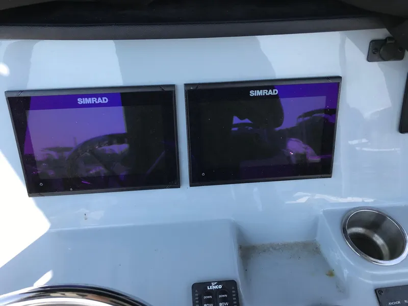 Slide: The Image of Dual Simrad displays on 2022 Bayliner Trophy T24CC dashboard. - 8