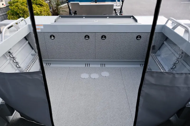 Slide: The Image of 2024 Hewescraft 180 Pro-V ET boat interior with spacious deck and storage compartments. - 10