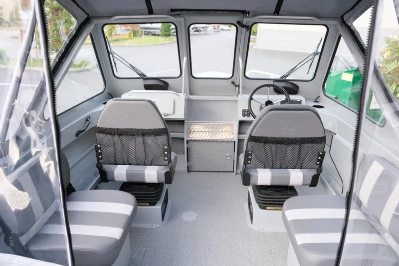 Slide: The Image of 2024 Hewescraft 180 Pro-V ET boat interior with seating and steering wheel. - 11