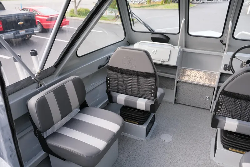 Slide: The Image of 2024 Hewescraft 180 Pro-V ET boat interior with gray seating and spacious cabin design. - 12